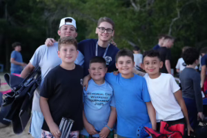 Campers posing with a Camp Lakota counselor during an evening gathering at the residential summer camp in Wurtsboro, New York