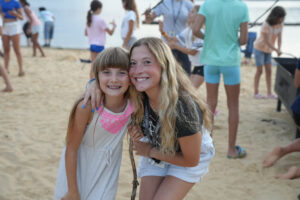 camp lakota counselor with camper on the beach